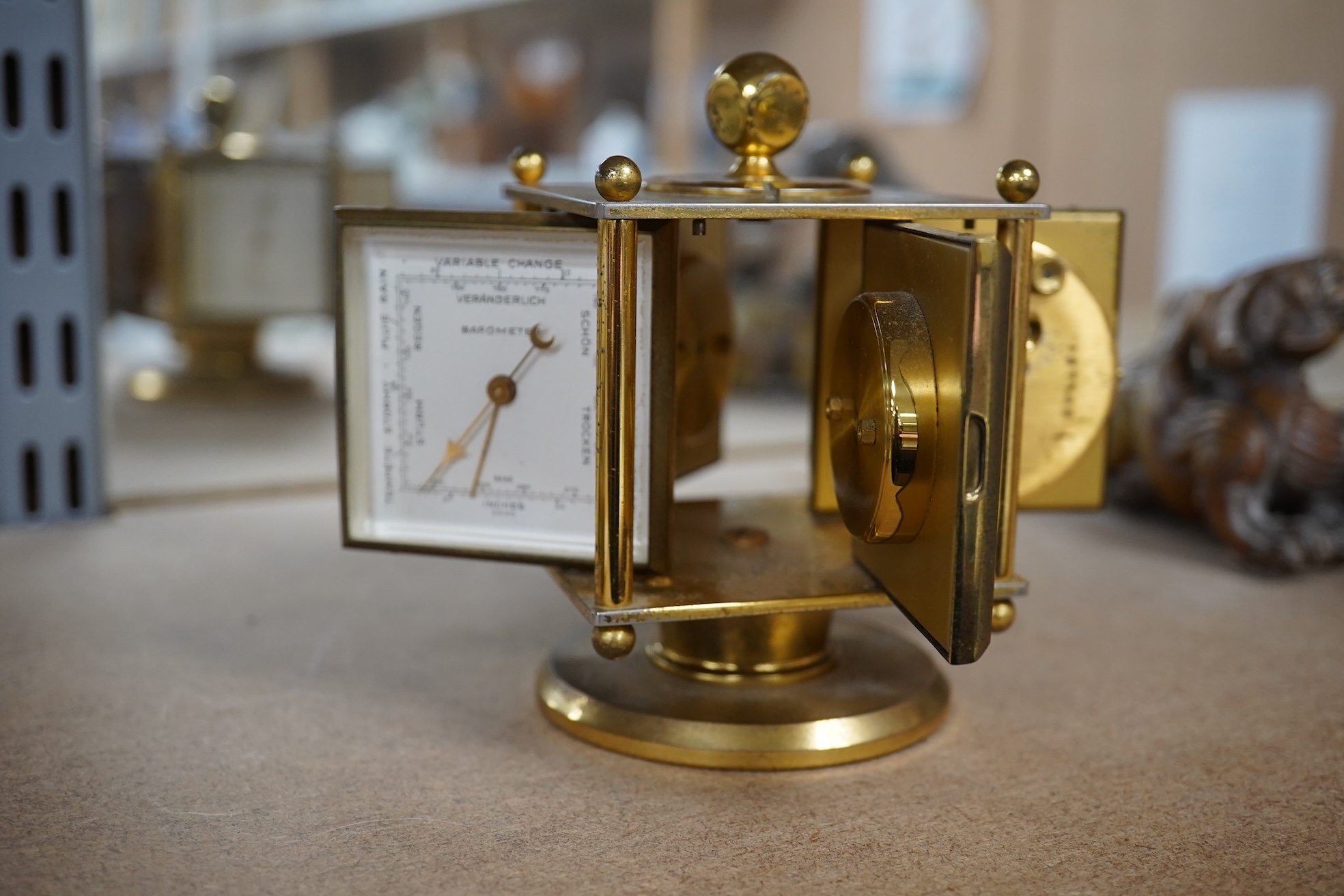 An Imhof brass combination clock, hydrometer, barometer and thermometer, 12cm high. Condition - fair